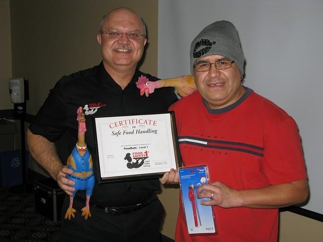 Food Safety 1st, Russell Scott presents Israel Solís of Delta Regina the 5,000th Food Safety 1st certificate